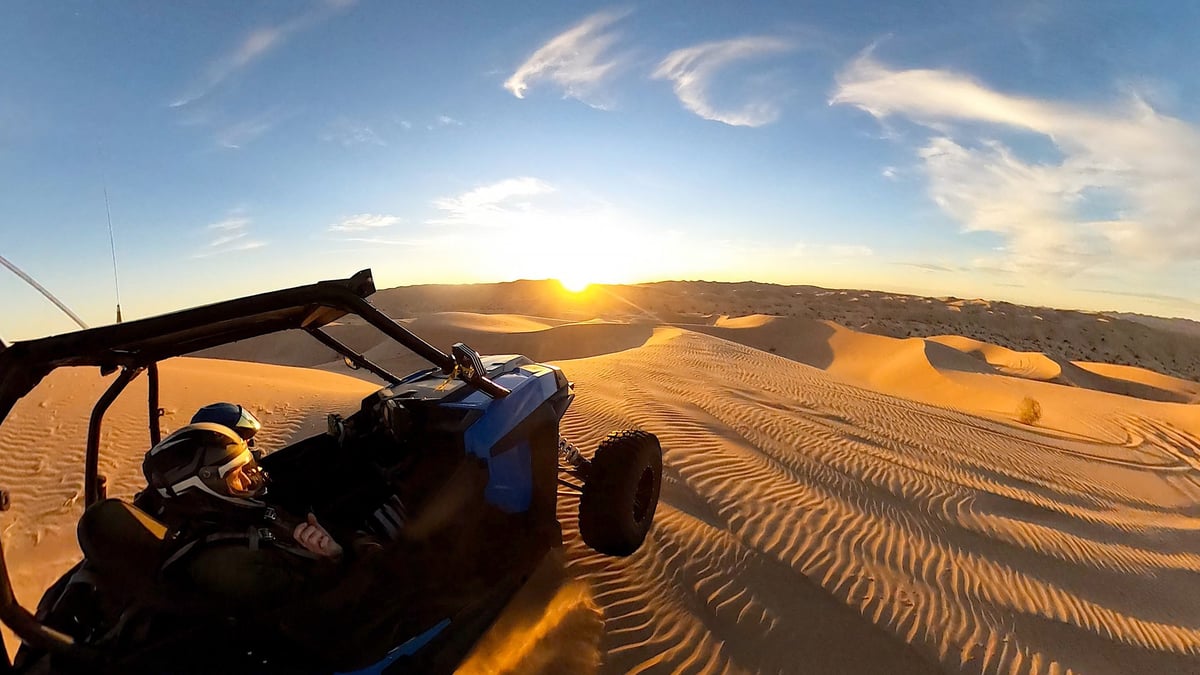 Single seater Polaris RS1 solo buggy climbing a desert sand berm in Dubai