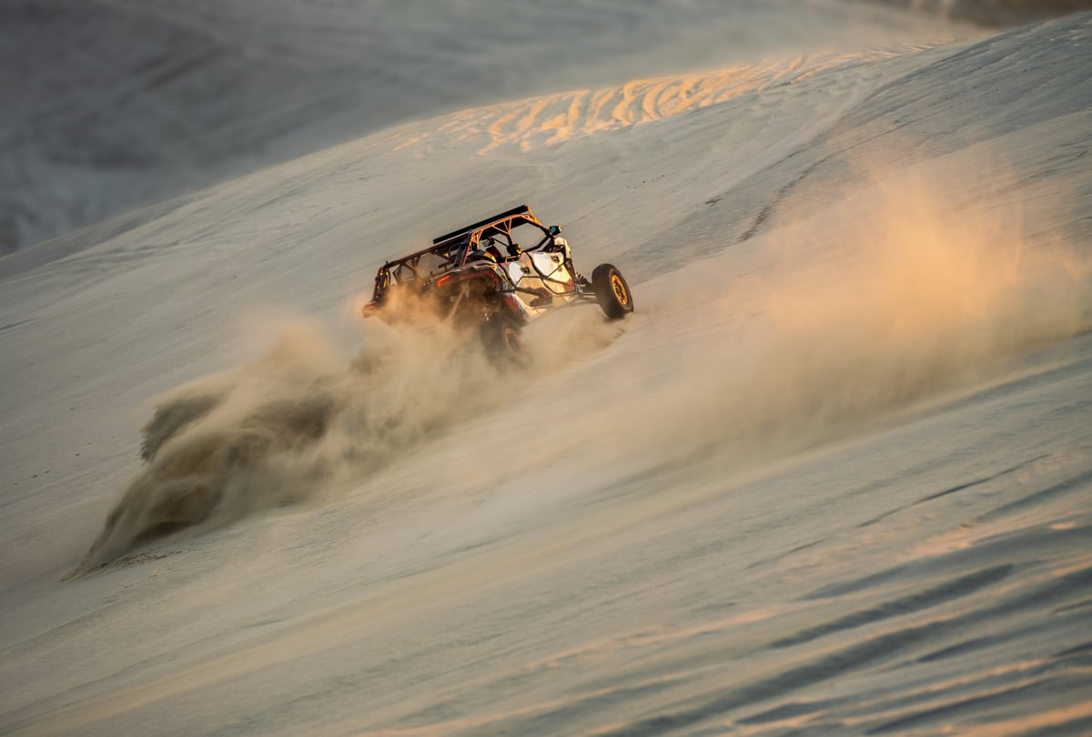 Desert racer buggy bashing sand dunes on an advanced Dubai off road route