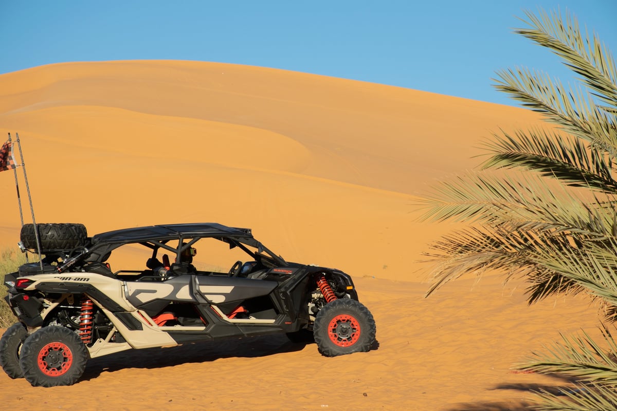 Driver wearing helmet and goggles in a desert buggy before a CanAm tour in Dubai